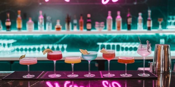 Assorted drinks with neon background