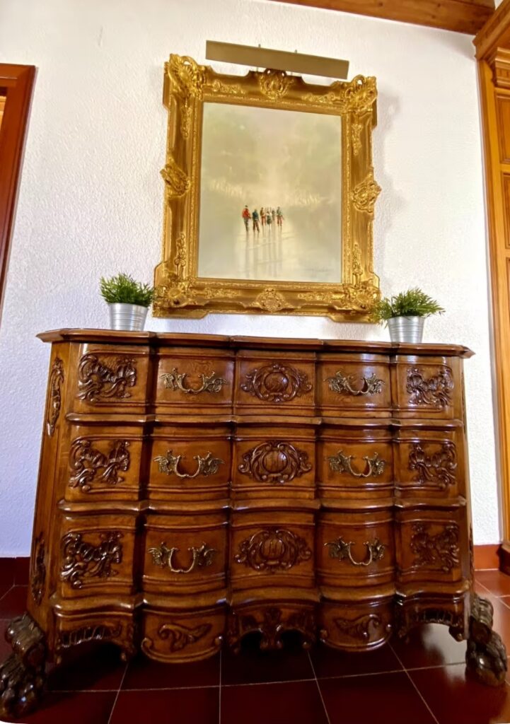 Ornate antique wooden dresser and gold-framed mirror inside the Divorce to Domination Retreat villa in Alicante