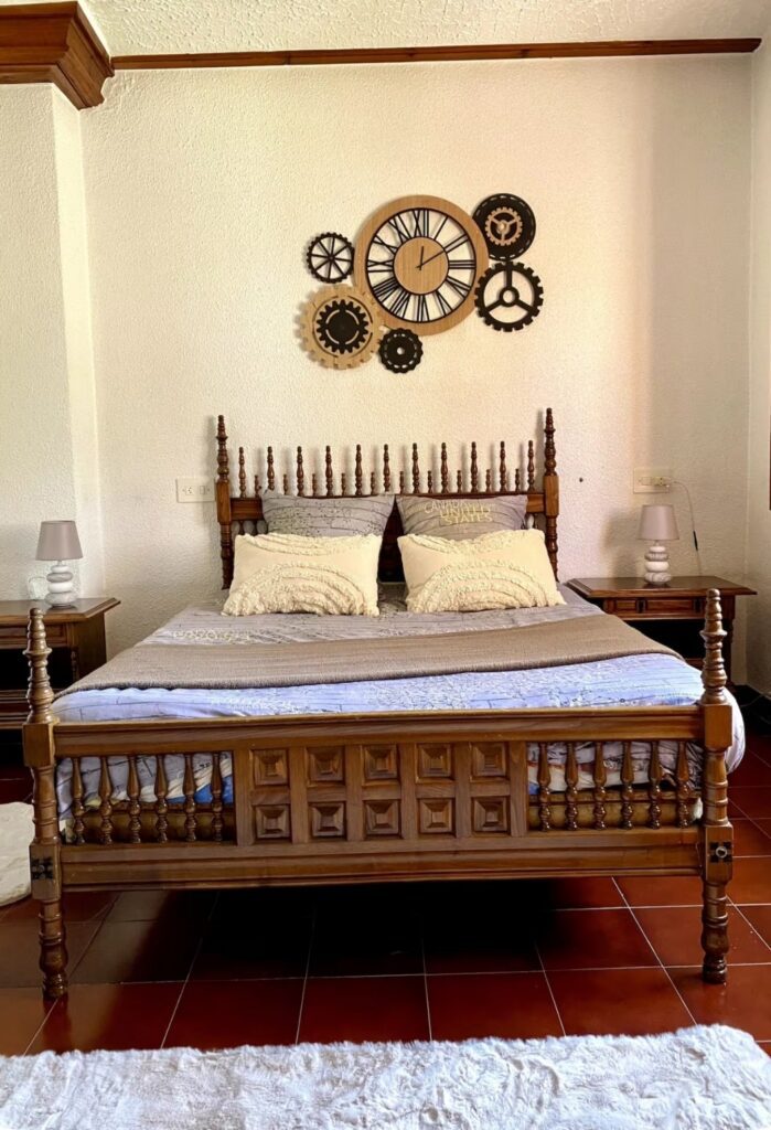 Traditional bedroom at the Divorce to Domination retreat in Alicante with ornate wooden four-poster bed