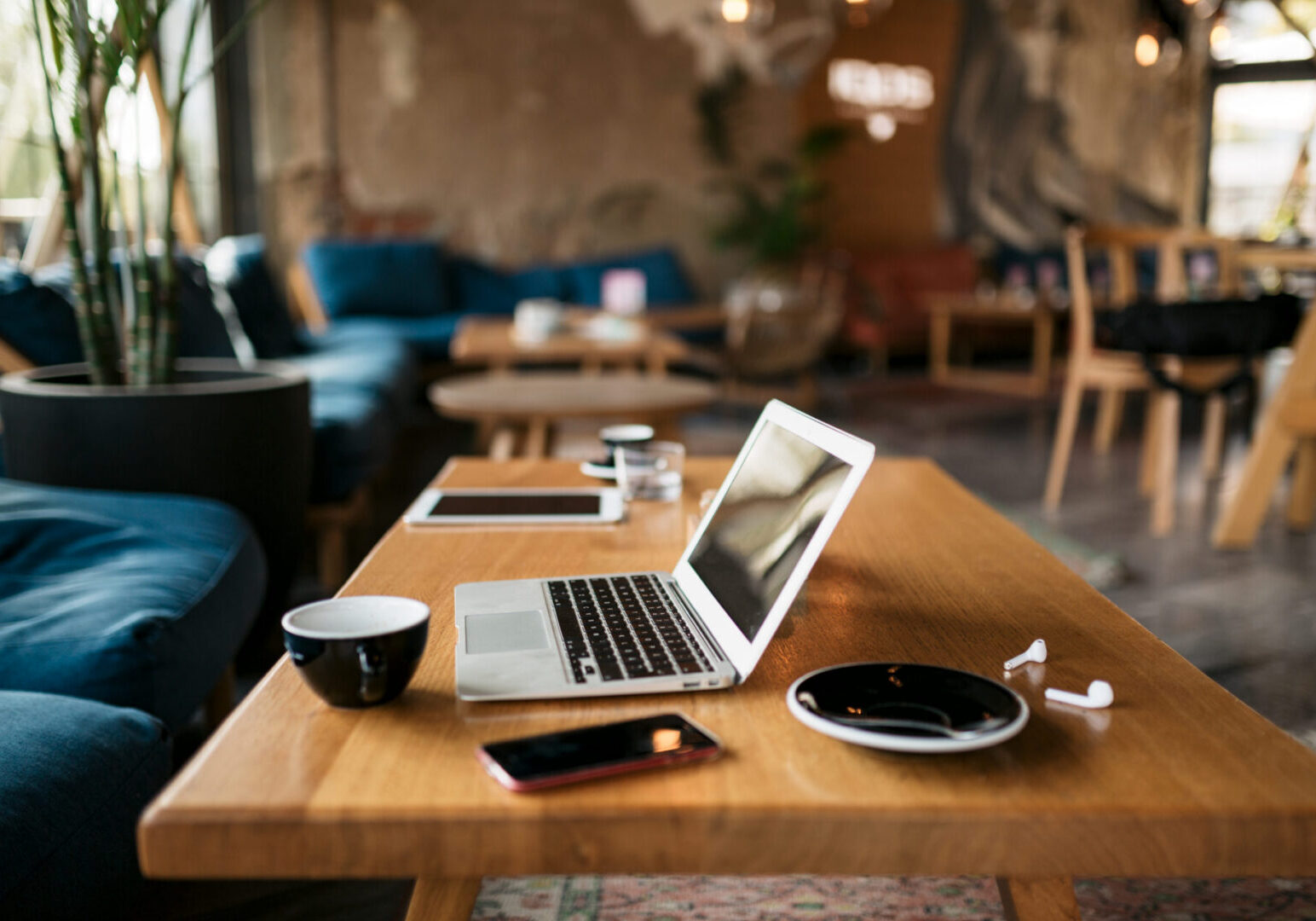 Freelancer's office with a laptop, smart phone, coffee and everything  essential and needed for a freelance online internet job and work