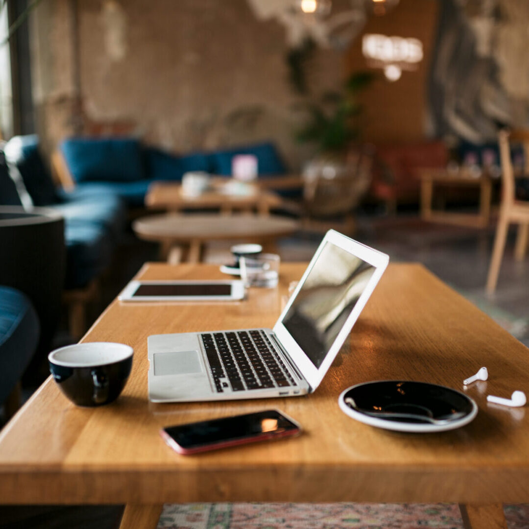 Freelancer's office with a laptop, smart phone, coffee and everything  essential and needed for a freelance online internet job and work