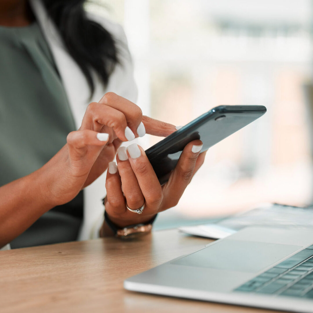 Phone, office and business woman networking on social media, the internet or a mobile app. Technology, corporate and professional company leader browsing on a mobile device in her modern workplace.